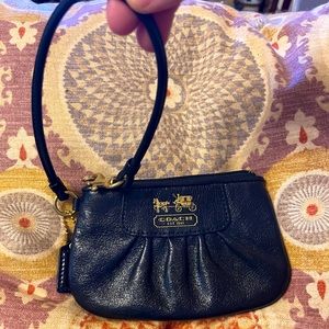 Very nice Coach wristlet coin purse. Excellent used condition. Interior purple